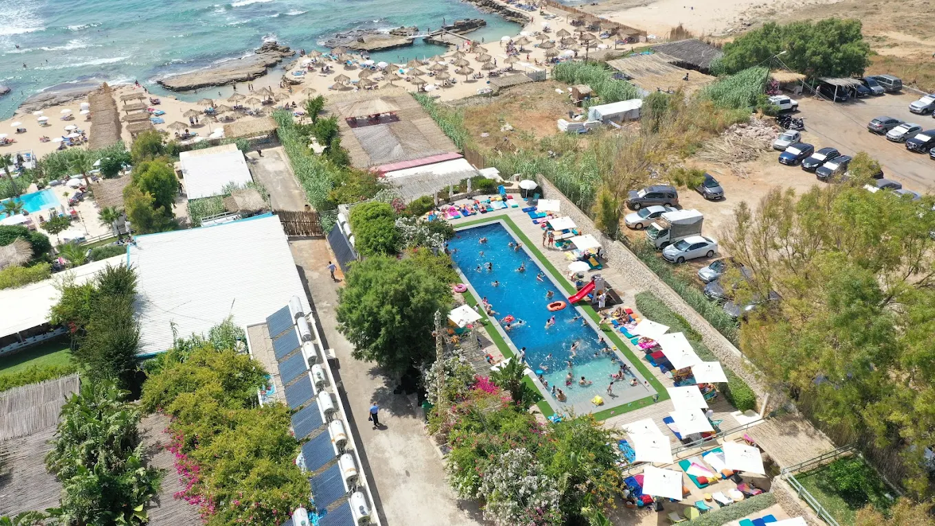 Aerial view of the Side B pool full of swimmers on a summer day